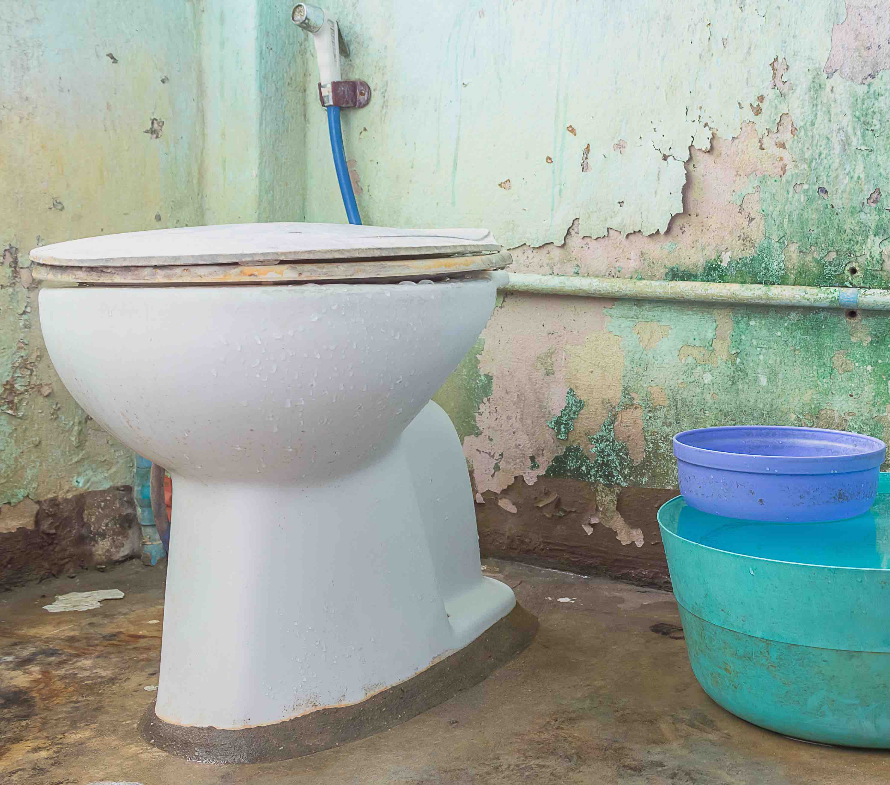 dirty old toilet bowl in bathroom.